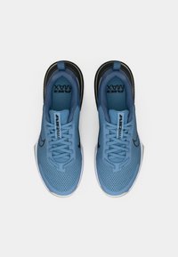 Light blue athletic shoes with a mesh upper, black accents, and white soles. Features lace-up design and prominent "Air Max" branding.