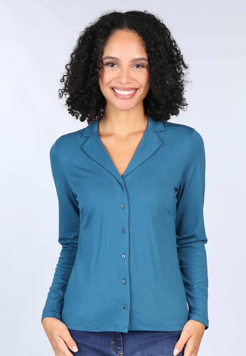 Teal long-sleeve shirt with a button-down front, collar, and soft, smooth fabric. Features a fitted cut and simple design.