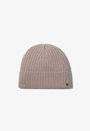 Knit beanie in light beige with a textured pattern, featuring a ribbed cuff and a small logo tag on the side. Soft, warm material.