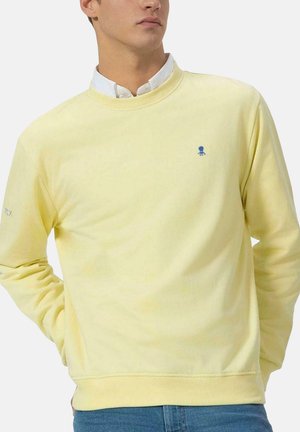 Sudadera de algodón amarilla con cuello redondo, puños acanalados y un logo de pulpo azul en el pecho. Textura suave, diseño casual.