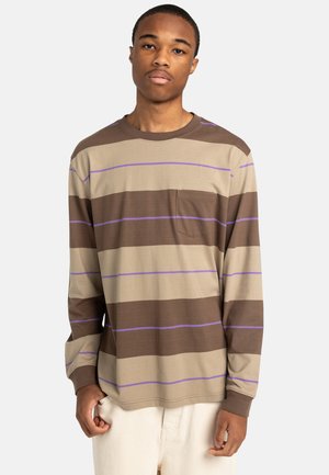 Long-sleeve striped t-shirt in beige with brown and purple stripes. Features a chest pocket and crew neckline. Cotton material, relaxed fit.