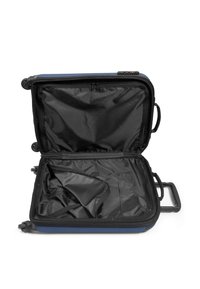 Hard-shell suitcase with a navy exterior, zippered opening, and black fabric interior. Includes a retractable handle and wheels for mobility.