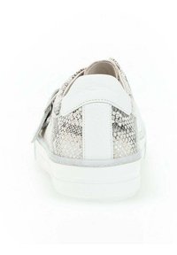 Sneaker with a textured silver snakeskin pattern, white leather accents, a white sole, and a rounded toe design. Laces at the front.