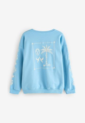 Sweatshirt bleu clair avec un graphique blanc représentant un palmier, des oiseaux et un cadenas. Il présente des poignets et un ourlet côtelés. Tissu doux et texturé.