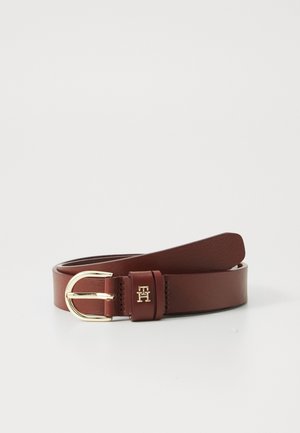 Brown leather belt with gold buckle and small gold "TH" logo on the belt loop, rolled up on a white background.