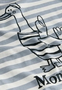 Striped light blue and white fabric featuring a black illustration of a duck in a striped shirt, with the text "Mon." visible below.