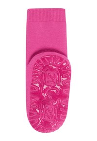 Rosa Socke mit einer strukturierten Gummisohle, die ein Sonnenstrahl-Muster aufweist. Der obere Teil ist glatt gestrickt und hat ein geripptes Bündchen für besseren Sitz und Halt.