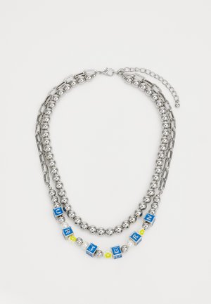 Collar de cadena de plata con dos capas, bolas redondas, fichas de letras azules y acentos florales. Incluye un cierre de langosta y cadena ajustable.