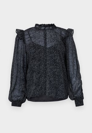 Svart blus med ett prickigt mönster, genomskinligt material, puffärmar och en volangkrage med knappknäppning bak.