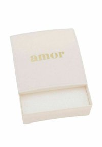 Małe, otwarte białe pudełko z napisem "amor" złotymi literami na pokrywie, ukazujące pustą wnętrze wyłożone miękkim wyściełaniem.