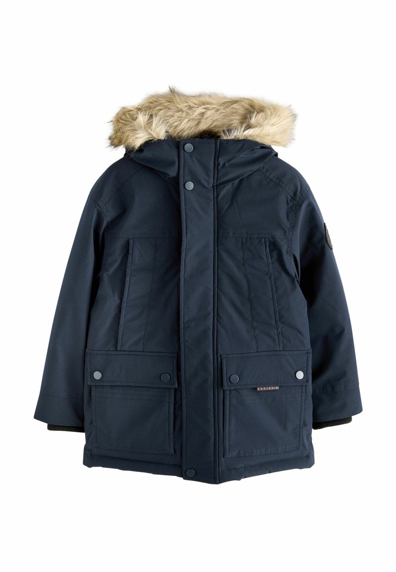 Parka imperméable bleu marine avec bordure en fausse fourrure sur la capuche, deux poches avant, fermetures à pression et poignets élastiques. Le matériau semble lisse et isolé.