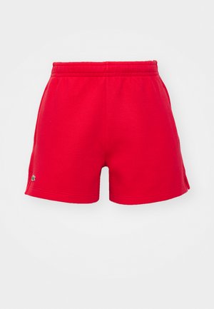 Røde shorts laget av myk stoff, med elastisk liv og en liten logo detalj på venstre side. Klassisk snitt med en glatt tekstur.