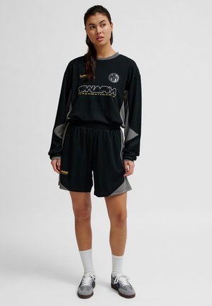 Hummel LOOSE TOPSCORER - Tracksuit bottoms - black