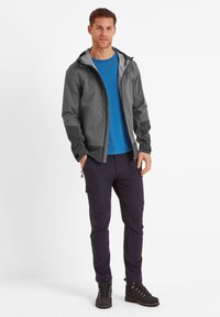Gray waterproof jacket, blue t-shirt, navy pants, and black boots. Features a lightweight design with a zipper and adjustable hood.