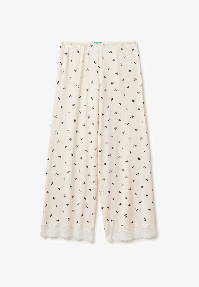 Světlé béžové kalhoty s květinovým vzorem obsahujícím malé červené a zelené motivy, doplněné bílou krajkou na spodním lemu. Elastický pas.