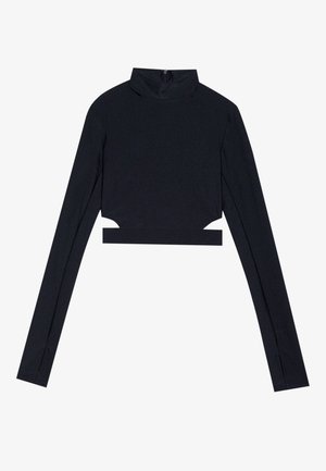 Cămașă scurtă neagră cu mâneci lungi, guler fals, închidere cu fermoar la spate și detalii tăiate pe laturi. Material neted cu textură minimală.
