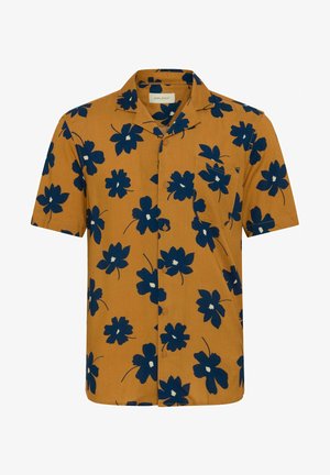 Kratki rukav, košulja s gumbima u senfu žutoj boji s mornarsko plavim cvjetnim uzorkom i džepom na prsima. Tkanina ima glatku, laganu teksturu.