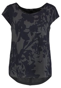 Blusa corta de manga corta en gris oscuro con un patrón floral en negro. Cuenta con un escote redondeado y un bolsillo en el pecho. Dobladillo curvado en la parte posterior.