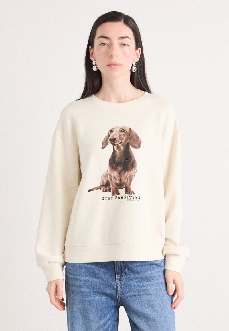 Krema barve sweatshirt z natisnjenim rjavim taksijem in besedilom "OSTANI PAWSITIVEN." Mehek tkanina, sproščen kroj, rebrasti manšeti in rob.