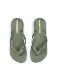 Green flip-flops with a textured sole, featuring sparkly silver straps and a gold accent. Brand name on a beige label.
