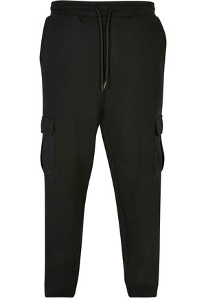 Svarta cargobyxor i sweatshirtmaterial med elastisk midja och snörning. Har sidofickor med lock och en slim-fit nedtrappande design.