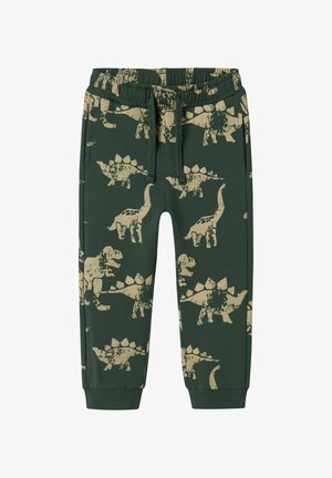 Groene joggerbroek voor kinderen met beige dino-patronen, elastische tailleband met trekkoord en zijzakken.