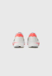 Sport shoes with a silver upper, white accents, and bright coral heel. Features a smooth texture and cushioned white midsole.