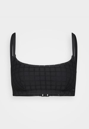 Black lace bralette featuring geometric patterns, adjustable straps, and a hook closure at the back. Soft texture and fitted design.