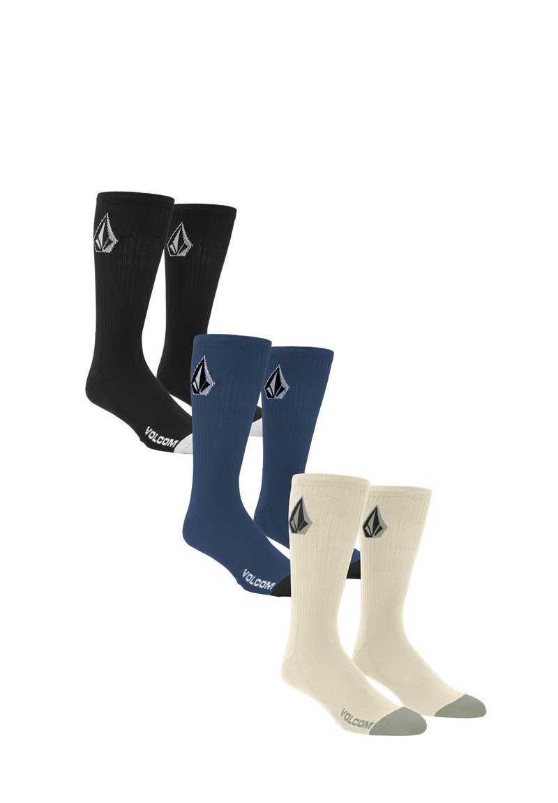 Trois paires de chaussettes de marin : noires, bleu marine et crème. Chacune a une texture côtelée et présente un logo. La paire crème a des accents gris.