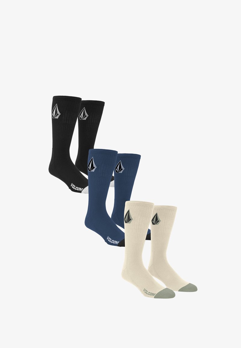 Trois paires de chaussettes de marin : noires, bleu marine et crème. Chacune a une texture côtelée et présente un logo. La paire crème a des accents gris.