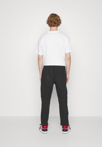 Nike Sportswear TECH FLEECE OPEN HEM PANT - Träningsbyxor - black