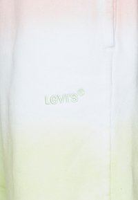 Sweatshirt Levi's dégradé du rose pâle au blanc puis au vert, avec un logo brodé en vert clair sur le devant. Texture de tissu douce.