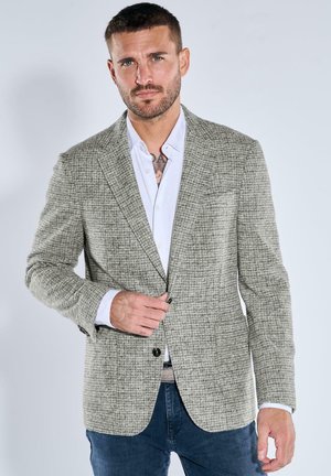 Light gray patterned blazer with a textured weave, single button closure, notched lapels, and front pockets, paired with a white shirt.