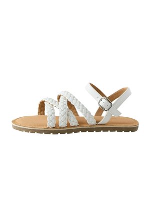 Flat sandal with three white braided straps across the foot and an adjustable white ankle strap with silver buckle, tan sole, textured tread.