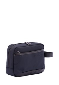 Borsa da toilettatura in nylon blu navy con superficie testurizzata, chiusura a zip, tasca frontale e manico laterale. Presenta accenti neri lisci.