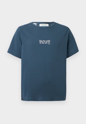 Blue short-sleeve t-shirt with round neck, featuring white text centered: "Take the world by the tail." and a small circular logo.