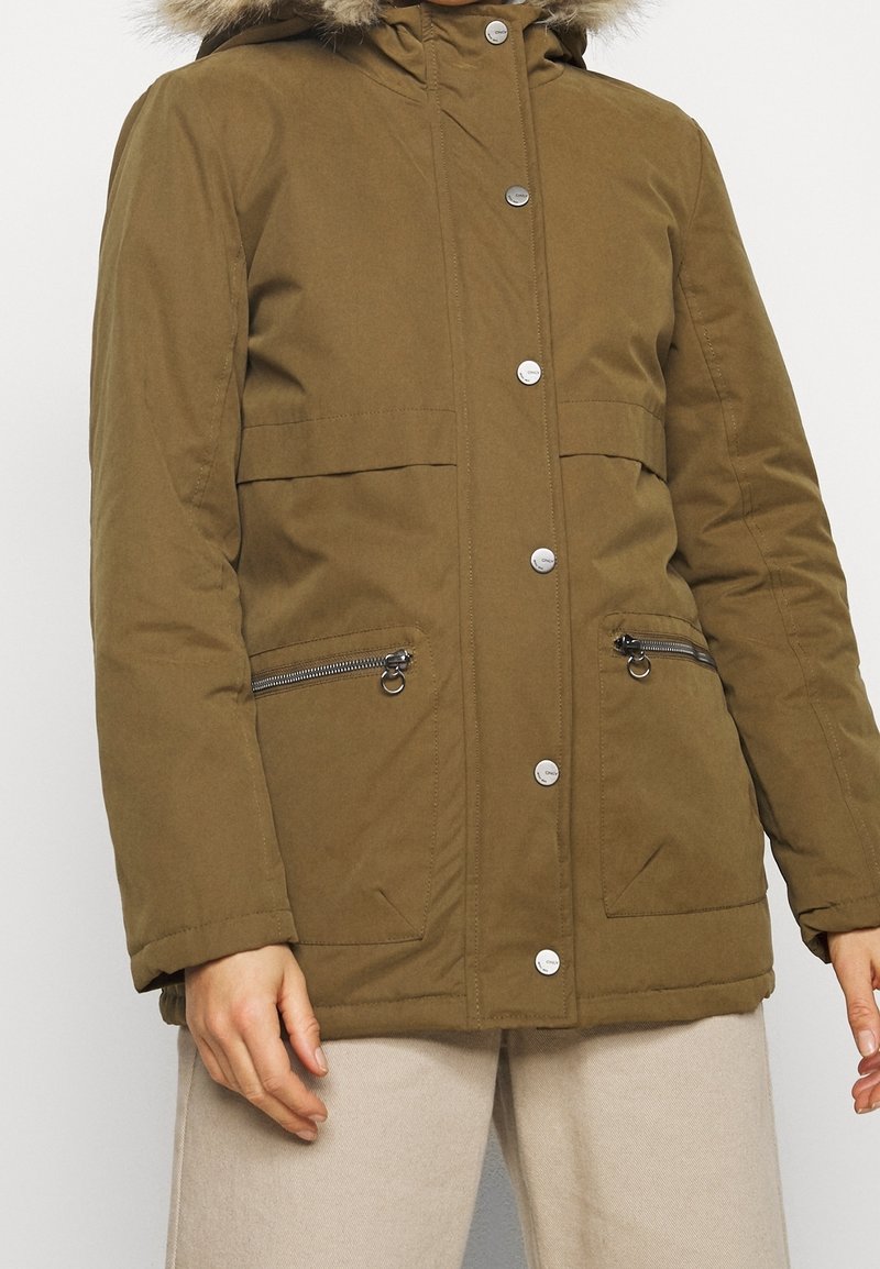 Olive green winter coat with a faux fur hood, zippered side pockets, snap buttons, and a quilted texture. Adjustable cuffs.