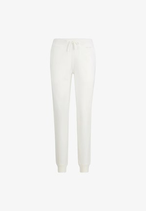 Pantalons de survêtement blancs avec taille à cordon, poches latérales, poignets ajustés et finition en tissu texturé. Associés à des baskets blanches.
