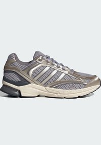Grey and silver athletic shoes with a mesh upper, metallic accents, padded collar, and a cushioned sole designed for support and comfort.