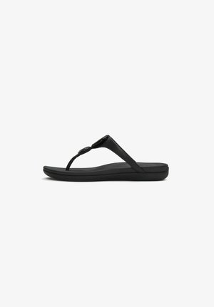 Black thong sandal with cushioned sole and round decorative buttons on the strap, shown in side view on white background.