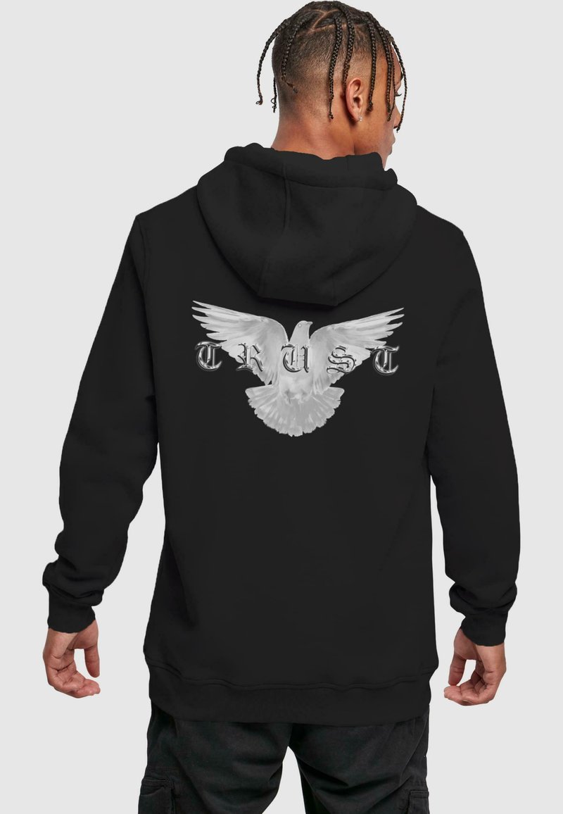 Haut à capuche noir présentant un grand graphisme en blanc d'une colombe en plein envol, avec le mot "CONFIANCE" en lettres argentées en dessous. Tissu doux avec une coupe décontractée.
