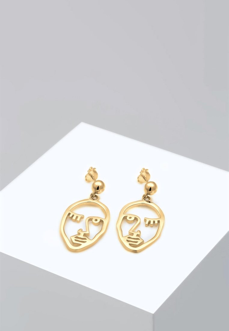 Guld metal øreringe med et minimalistisk ansigtssilhuetdesign, hængende fra en lille rund kuglestik, med en poleret finish.