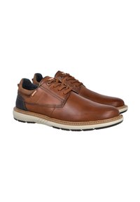 Zapatos de cuero marrón con un acabado suave, punta redonda y tacón oscuro en contraste. Cuentan con cordones y una suela de goma beige ligera.