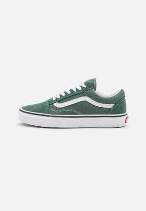 Green canvas sneakers with white laces and side stripe, featuring a white rubber sole and black accent around the midsole.