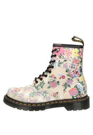 Blumenmuster-Lace-up-Stiefeletten aus beigem synthetischem Material mit schwarzen Akzenten und gelben Nähten. Mit einer robusten schwarzen Sohle.