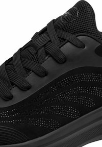 Must musteline spordijalats, millel on tekstuuriga pealisosa, sisaldades võrkkangast, kunstnahka ja nööpe. Ümmargune varvas, lamedad paelad ja sujuv profiil.