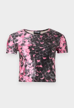Short-sleeve crop top with a pink and black scaled pattern resembling fish or reptile scales, featuring a round neckline and a brand label inside.