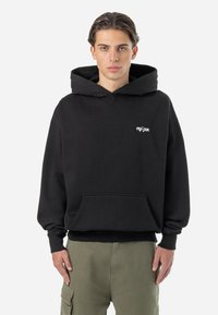 Black hoodie made of cotton with a front pocket and ribbed cuffs. Features a small white logo on the left chest area.