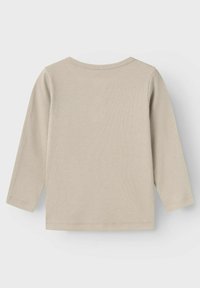 Beige langermet skjorte med ribbet tekstur og rund hals. Enkel design med rett kutt og kantede kanter. Ingen trykte detaljer.