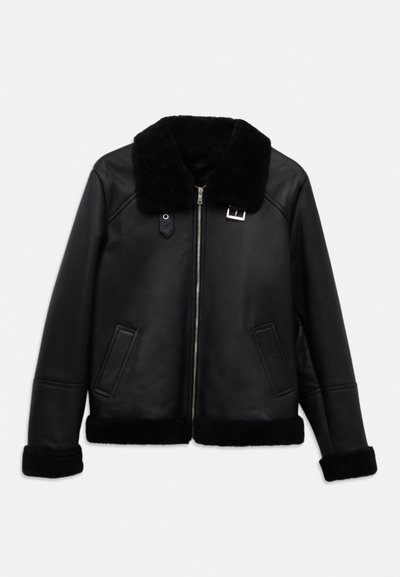 Must must jacket, milledeish kollar, esi ttagav ja kaks küljetaskut. Kätte ja hemline on samuti kaetud milledeiga.